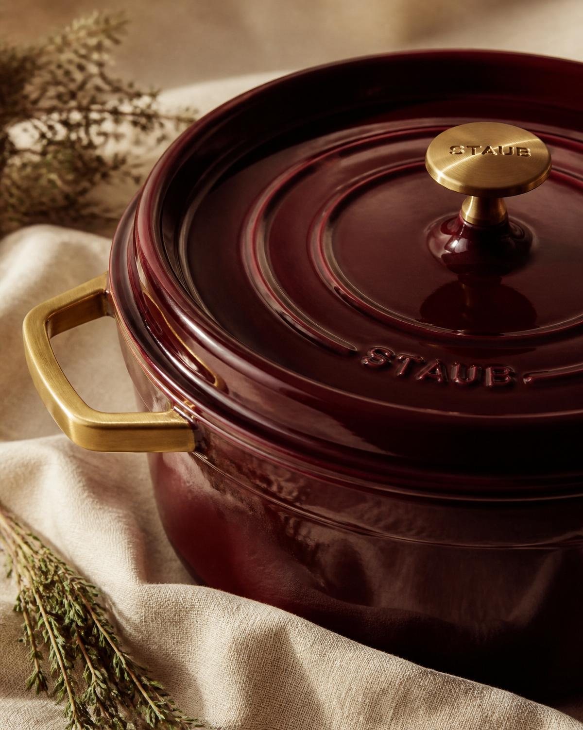 Deep burgundy enamel pot with soft gold handles